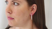 Load and play video in Gallery viewer, Sterling Silver CZ 46 Stones In and Out Oval Hoop Earrings
